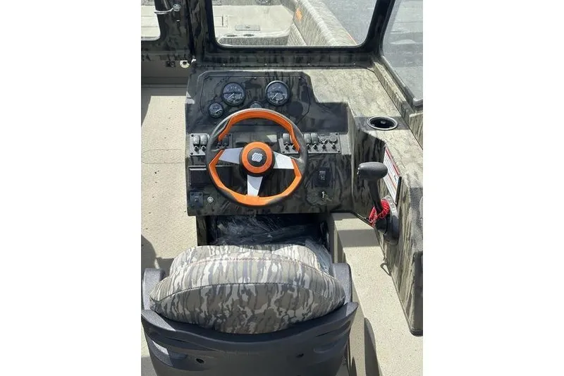Slide: The Image of 2026 SeaArk EasyCat boat dashboard with orange steering wheel and camo seat. - 8