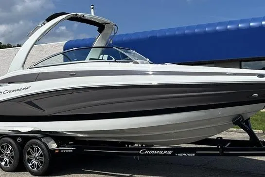 The Image of 2026 Crownline 270 SS boat on trailer, sleek design, white and black exterior. - 1