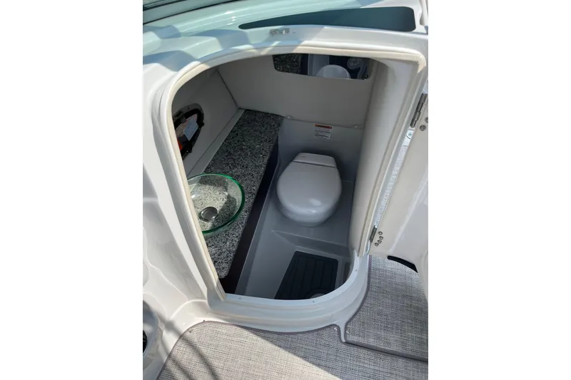 Slide: The Image of 2026 Crownline 270 SS boat bathroom with modern sink and toilet. - 12