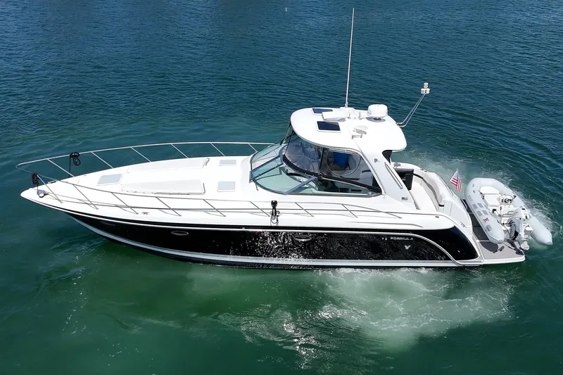 Slide: The Image of 2005 Formula 40 Performance Cruiser on clear blue water, side view. - 11