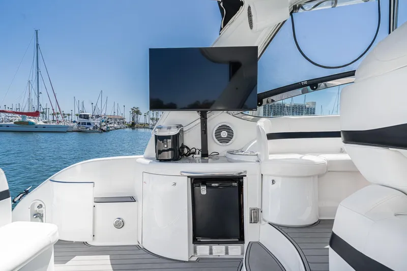 Slide: The Image of Luxurious 2005 Formula 40 Performance Cruiser interior with TV, fridge, and marina view. - 19