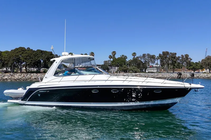 Slide: The Image of 2005 Formula 40 Performance Cruiser yacht on water, sunny day, coastal background. - 4