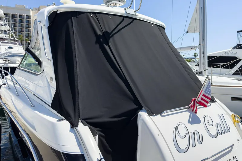 Slide: The Image of 2005 Formula 40 Performance Cruiser docked, rear view with black cover and American flag. - 48