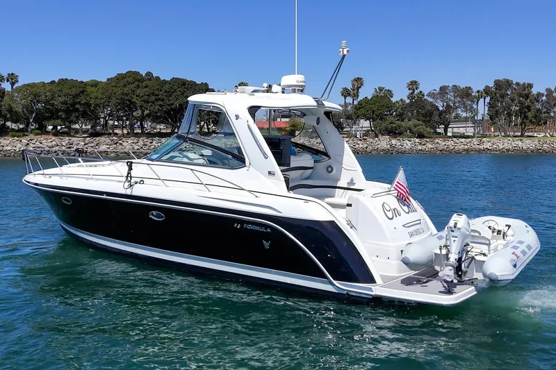 Slide: The Image of 2005 Formula 40 Performance Cruiser on water, featuring sleek design and American flag. - 5