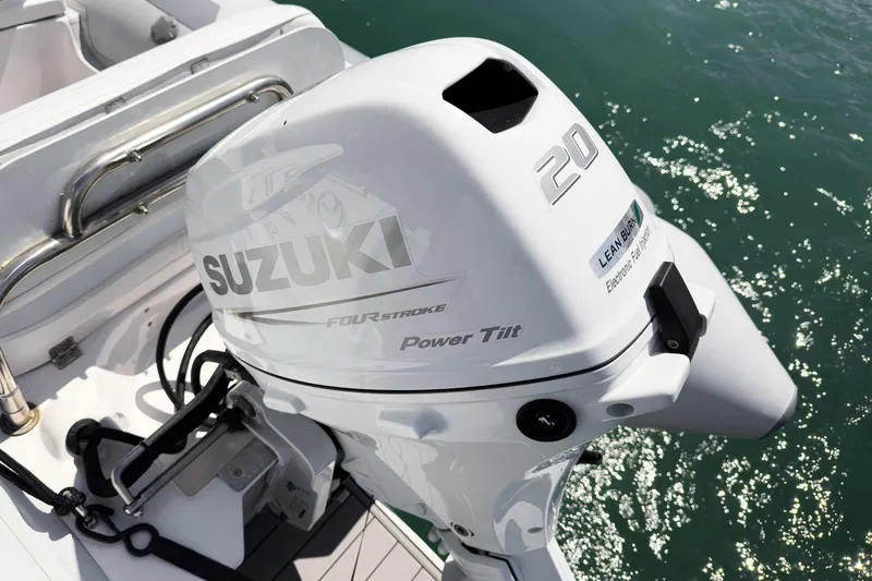 Slide: The Image of Suzuki 20HP outboard motor on 2005 Formula 40 Performance Cruiser, docked on water. - 50