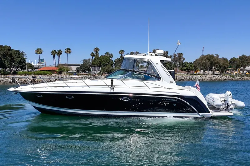 Slide: The Image of 2005 Formula 40 Performance Cruiser on water, sunny day, palm trees in background. - 8
