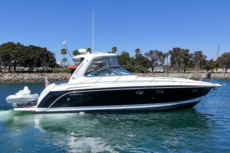 Slide: The Image of 2005 Formula 40 Performance Cruiser on water, sunny day, coastal background. - 9