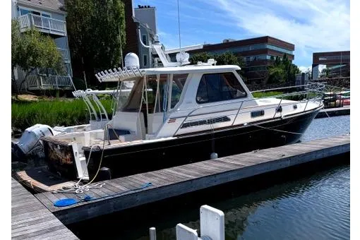 The Image of 2006 Sabre 38 Hard Top Express docked at a marina, side view. - 1