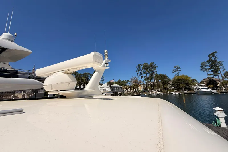 Slide: The Image of 2022 Sabre 38 Salon Express yacht docked in a marina under clear blue skies. - 13