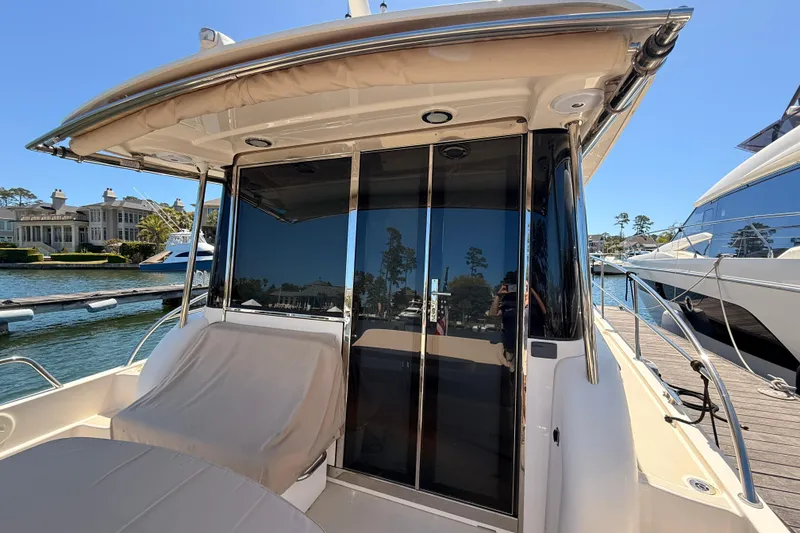 Slide: The Image of 2022 Sabre 38 Salon Express yacht docked, featuring sleek design and spacious seating area. - 15