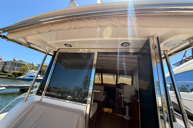 Slide: The Image of 2022 Sabre 38 Salon Express yacht interior view with open sliding doors. - 16