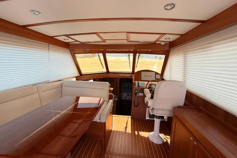 Slide: The Image of Interior of 2022 Sabre 38 Salon Express yacht with elegant wood finish and modern helm. - 18