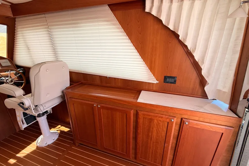 Slide: The Image of Interior of 2022 Sabre 38 Salon Express with wooden cabinetry and helm seat. - 19