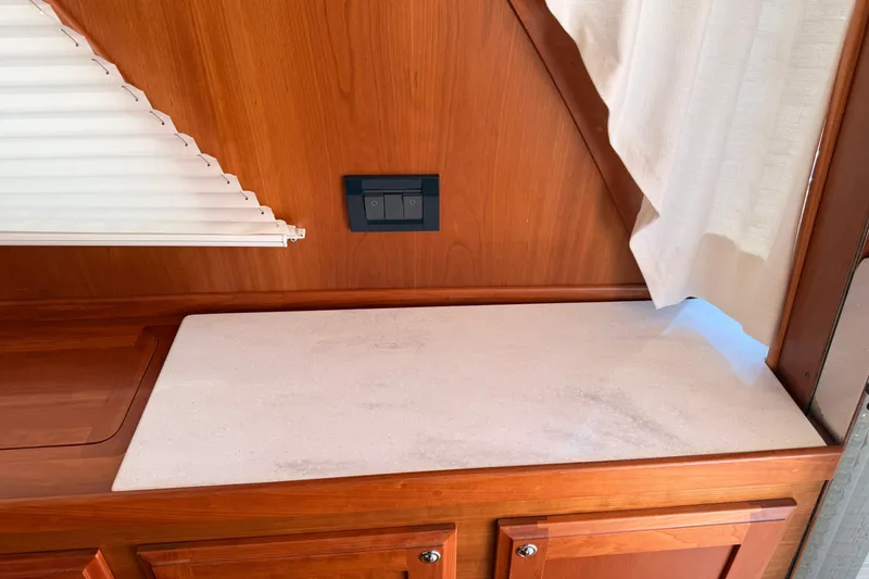 Slide: The Image of Interior of 2022 Sabre 38 Salon Express with wooden cabinetry and countertop. - 20