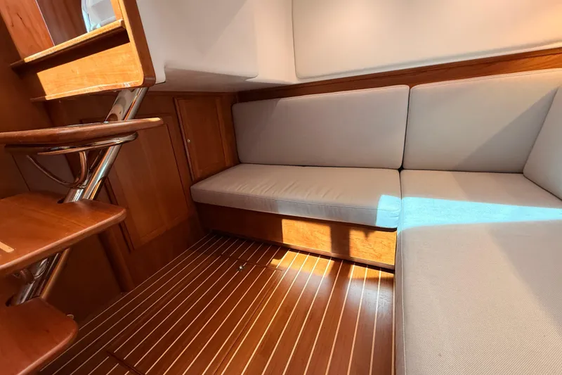 Slide: The Image of Interior of 2022 Sabre 38 Salon Express with wooden flooring and cushioned seating. - 37