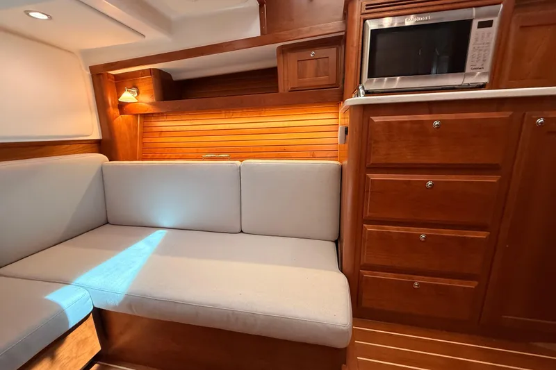 Slide: The Image of Interior of 2022 Sabre 38 Salon Express with cozy seating and wooden cabinetry. - 38
