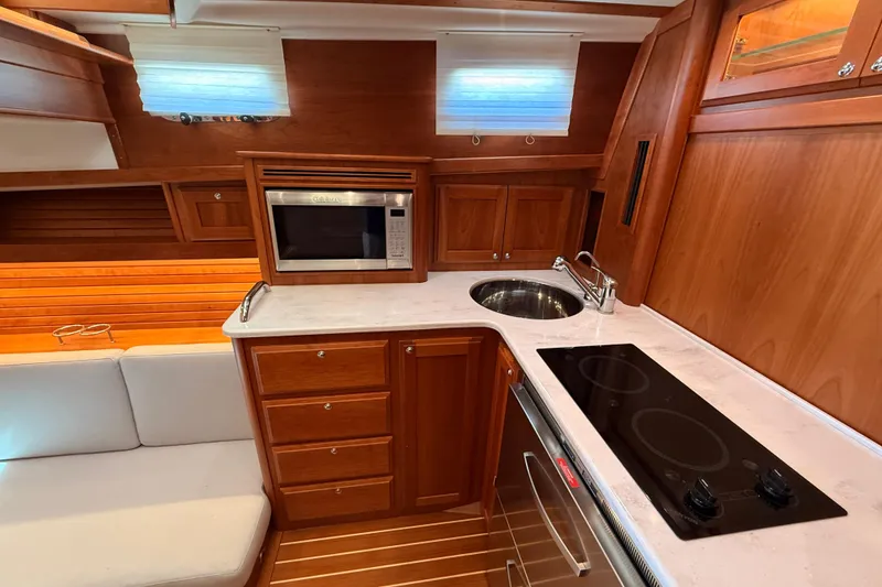 Slide: The Image of Luxurious 2022 Sabre 38 Salon Express galley with wood cabinetry and modern appliances. - 39