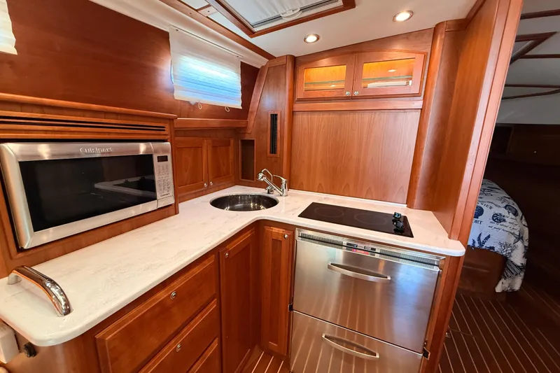 Slide: The Image of Luxurious 2022 Sabre 38 Salon Express galley with modern appliances and elegant wood cabinetry. - 40