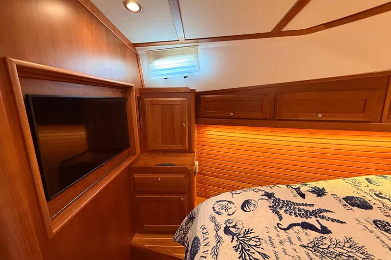 Slide: The Image of Luxurious 2022 Sabre 38 Salon Express cabin with wood paneling and built-in TV. - 42