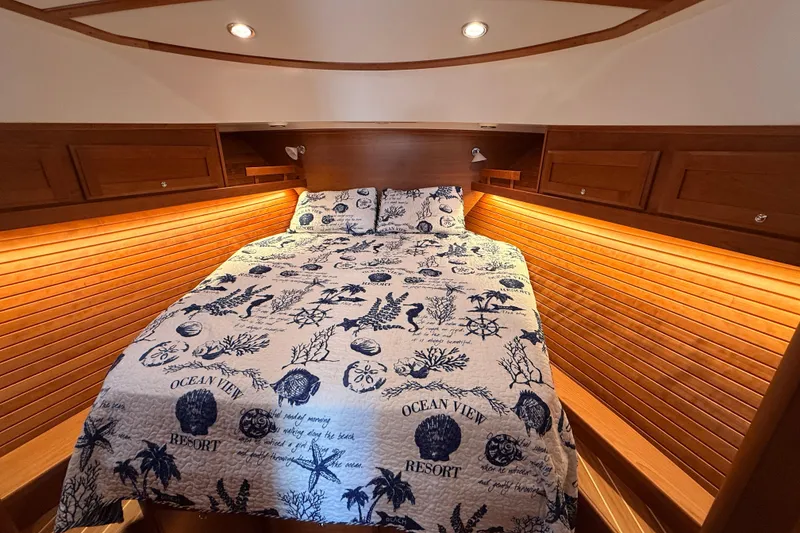 Slide: The Image of Luxurious cabin interior of 2022 Sabre 38 Salon Express with nautical-themed bedding. - 43