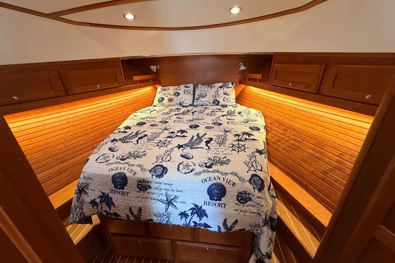 Slide: The Image of Luxurious cabin interior of 2022 Sabre 38 Salon Express with nautical-themed bedding. - 44