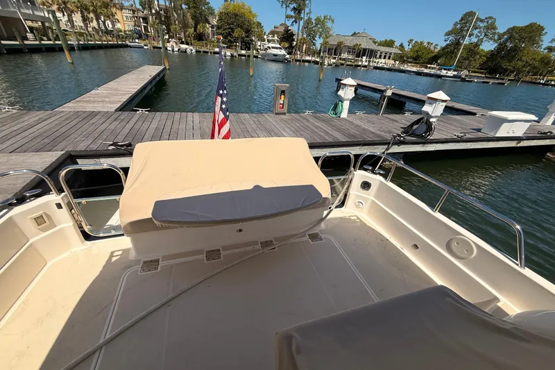 Slide: The Image of 2022 Sabre 38 Salon Express yacht docked at marina with American flag. - 53