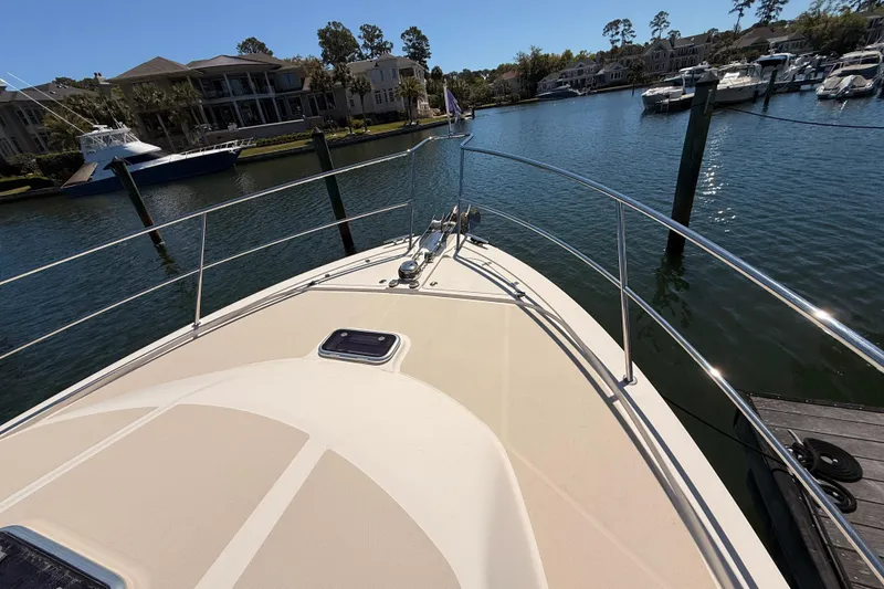 Slide: The Image of Bow view of 2022 Sabre 38 Salon Express yacht docked in a scenic marina. - 9