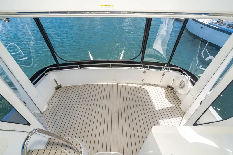 Slide: The Image of Spacious deck of 2002 Carver 396 Motor Yacht overlooking calm blue water. - 15