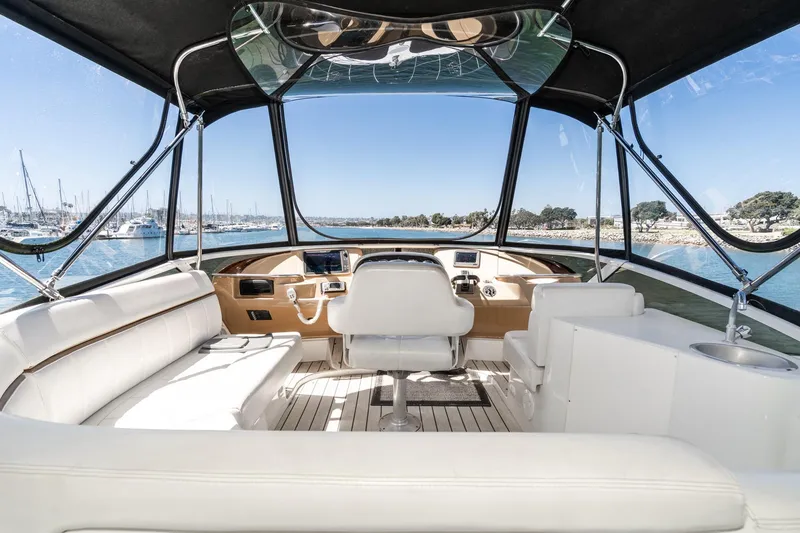 Slide: The Image of Interior view of 2002 Carver 396 Motor Yacht cockpit with panoramic marina view. - 19
