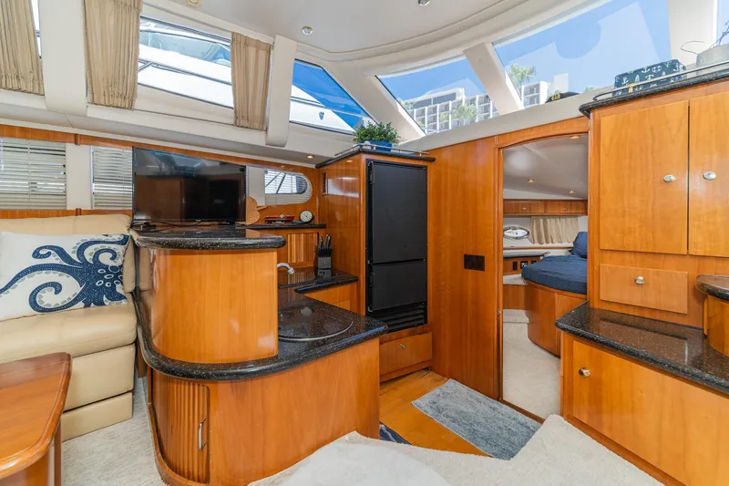 Slide: The Image of Luxurious interior of 2002 Carver 396 Motor Yacht with wood finishes and modern amenities. - 28