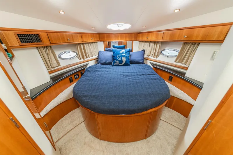 Slide: The Image of Luxurious 2002 Carver 396 Motor Yacht bedroom with elegant wood finish and cozy bedding. - 35