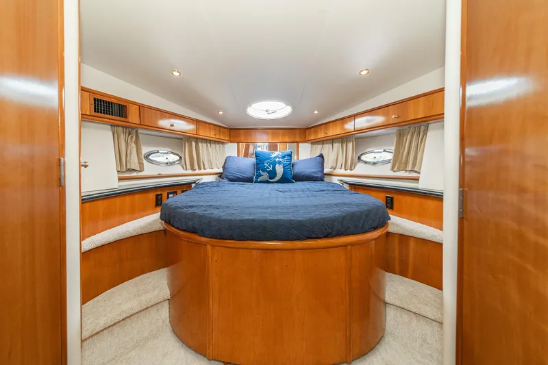 Slide: The Image of Luxurious bedroom interior of 2002 Carver 396 Motor Yacht with wood accents and round bed. - 36