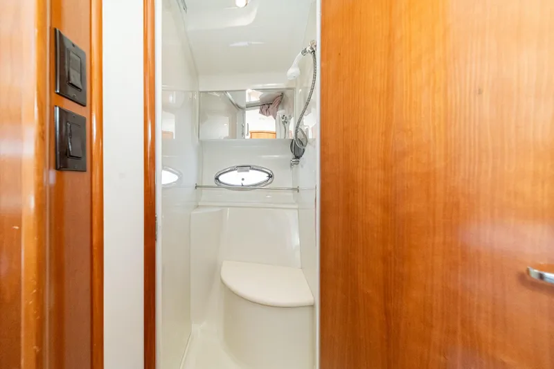 Slide: The Image of 2002 Carver 396 Motor Yacht bathroom with wooden door and oval window. - 38