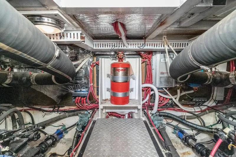Slide: The Image of Engine room of 2002 Carver 396 Motor Yacht with fire extinguisher and wiring. - 39