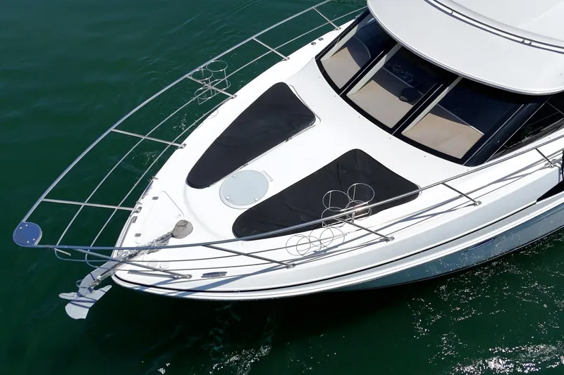 Slide: The Image of 2002 Carver 396 Motor Yacht on calm green water, aerial view. - 9