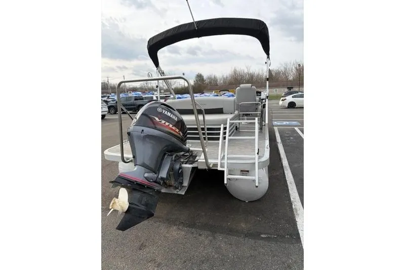 Slide: The Image of 2021 Bennington 22 SSBX pontoon boat with Yamaha outboard motor in parking lot. - 12