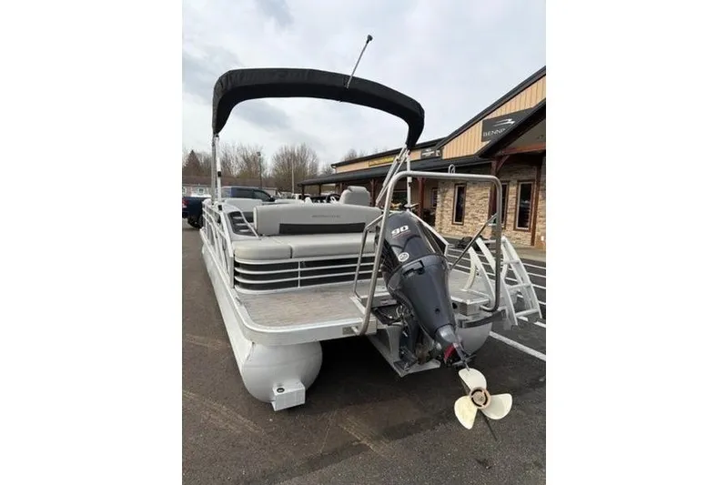 Slide: The Image of 2021 Bennington 22 SSBX pontoon boat with outboard motor, parked outdoors. - 13