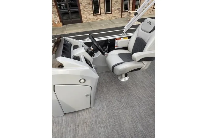 Slide: The Image of Captain's seat and helm of 2021 Bennington 22 SSBX pontoon boat, featuring modern controls. - 14