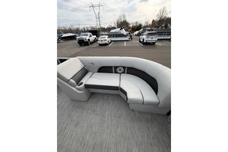 Slide: The Image of 2021 Bennington 22 SSBX pontoon boat with gray seating in a parking lot. - 16
