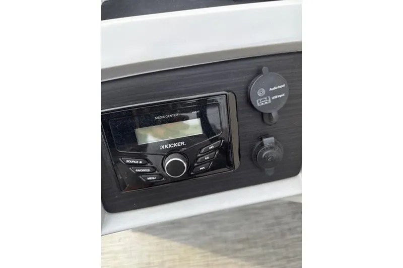 Slide: The Image of 2021 Bennington 22 SSBX boat dashboard with Kicker media center and audio input. - 18