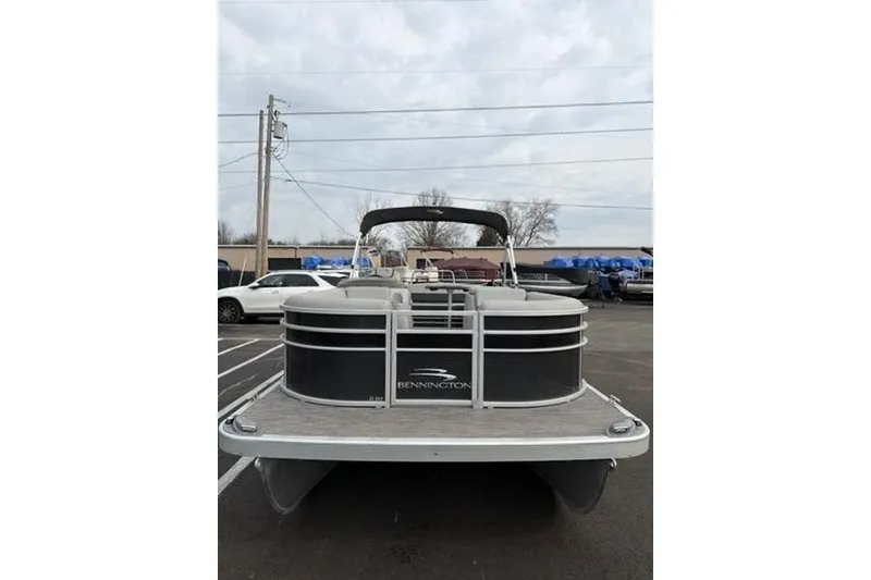 Slide: The Image of 2021 Bennington 22 SSBX pontoon boat parked outdoors on a cloudy day. - 3
