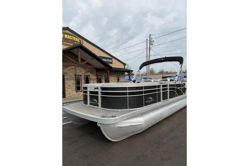 Slide: The Image of 2021 Bennington 22 SSBX pontoon boat parked outside a marine dealership. - 4