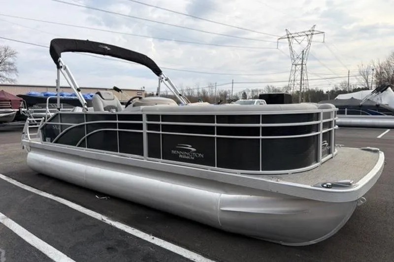 Slide: The Image of 2021 Bennington 22 SSBX pontoon boat parked outdoors on a cloudy day. - 5