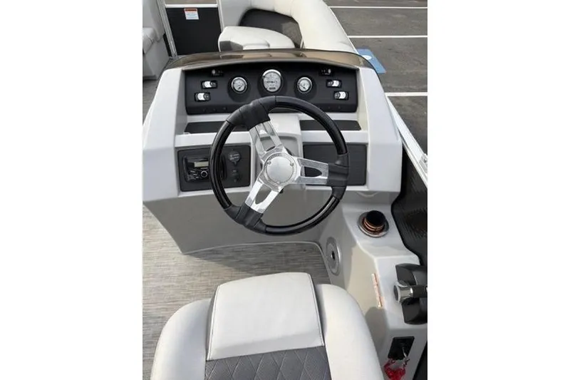 Slide: The Image of 2021 Bennington 22 SSBX boat dashboard with steering wheel and control panel. - 6