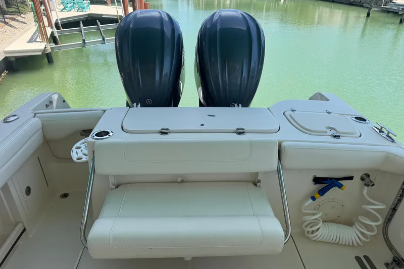 Slide: The Image of 2022 Grady-White Freedom 285 boat cruising on clear blue water. - 10