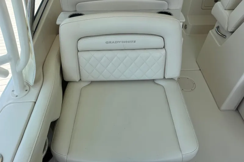 Slide: The Image of 2022 Grady-White Freedom 285 boat cruising on clear blue water under a cloudy sky. - 12