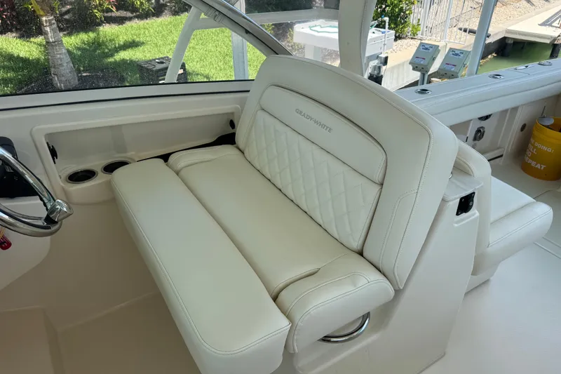 Slide: The Image of 2022 Grady-White Freedom 285 boat cruising on clear blue water. - 15