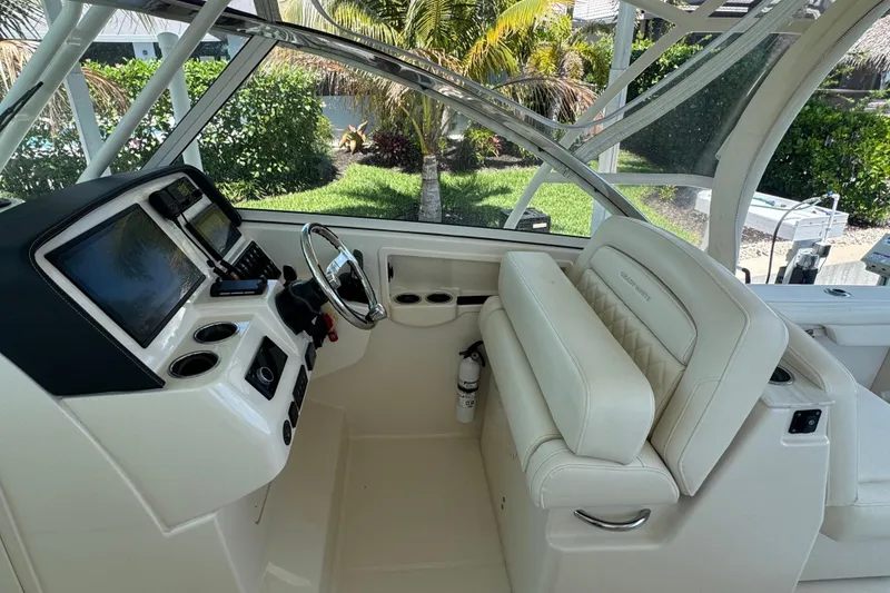 Slide: The Image of 2022 Grady-White Freedom 285 boat cruising on clear blue water under a sunny sky. - 16