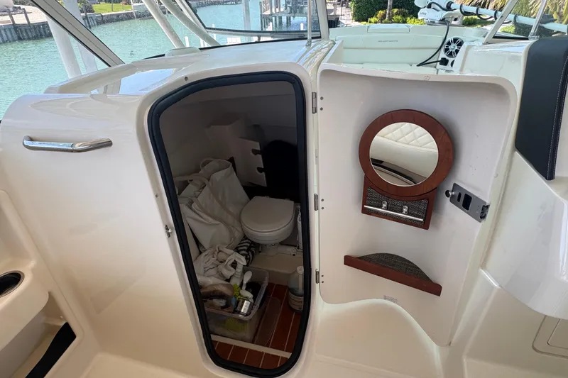 Slide: The Image of Twin Yamaha outboard engines on a 2022 Grady-White Freedom 285 boat in clear blue water. - 18