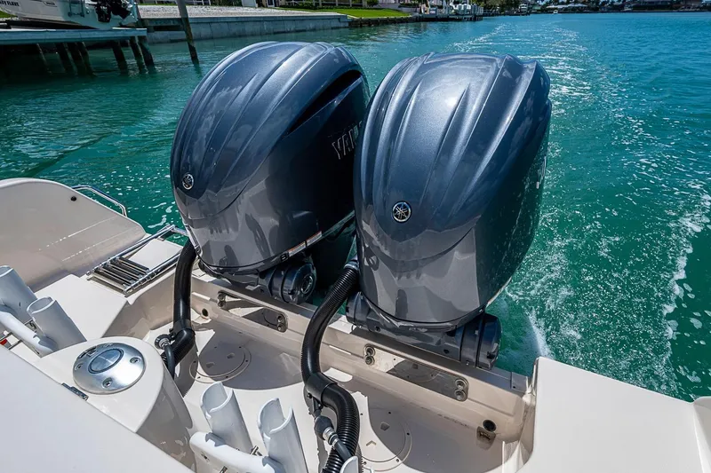 Slide: The Image of 2022 Grady-White Freedom 285 boat with dual outboard engines on turquoise water. - 20
